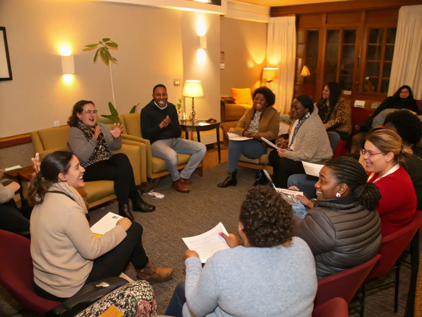 A heartwarming image of staff members and their families participating in a social support group meeting, sharing experiences and providing mutual support, highlighting the organization's commitment to fostering a supportive community environment.